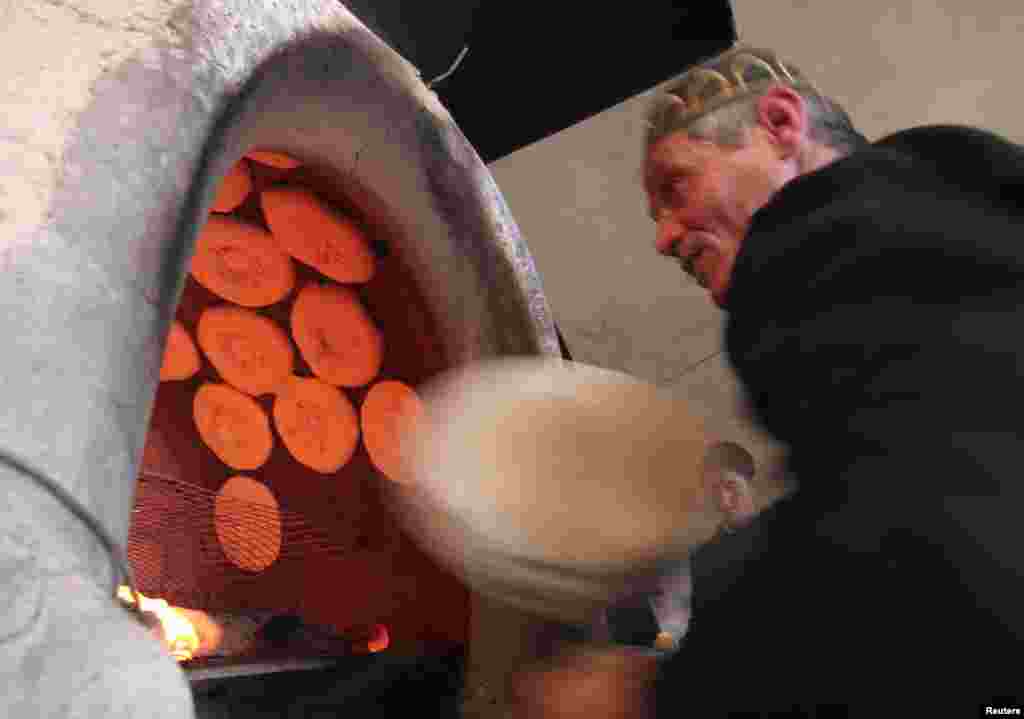 A baker places nan into a tandyr in the Tajik capital, Dushanbe.