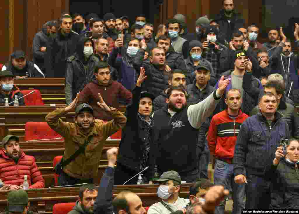 Demonstrators shout inside the parliament building. Parliament speaker Ararat Mirzoyan was hospitalized after being attacked during the protests. 