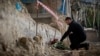 President Volodymyr Zelenskiy pays his respects to those were were killed when part of a Kyiv apartment block collapsed during a massive Russian drone and missile attack on the Ukrainian capital on July 17. 