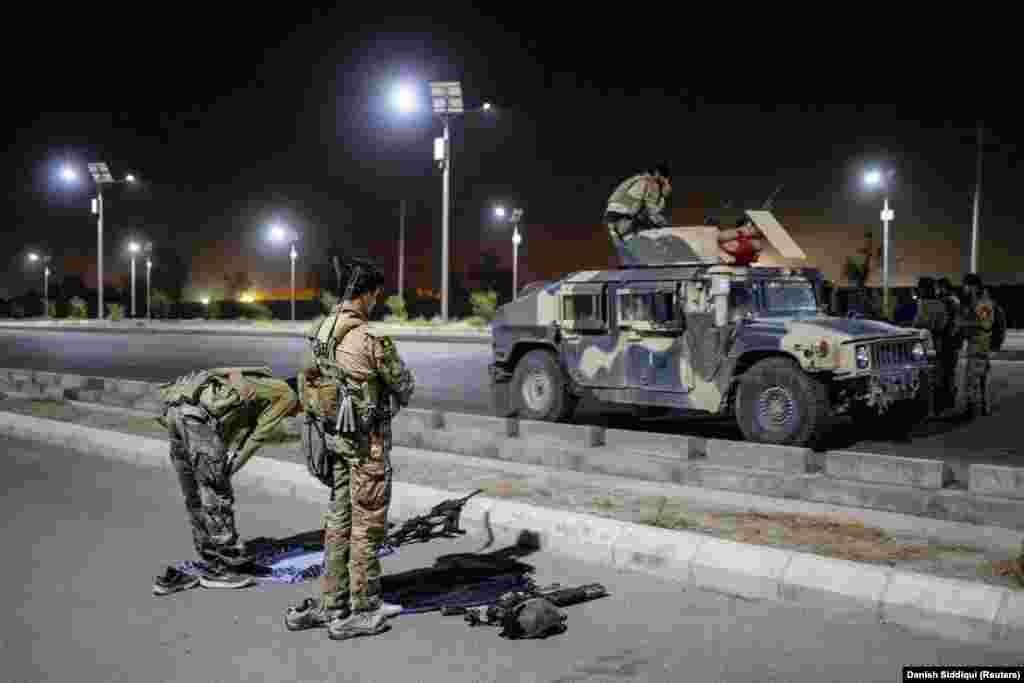 Special forces soldiers pray ahead of a nighttime mission in Kandahar on July 12. A commander told Reuters ahead of the assignment that he had received a report "that the enemy had infiltrated here and wanted to overthrow the district."