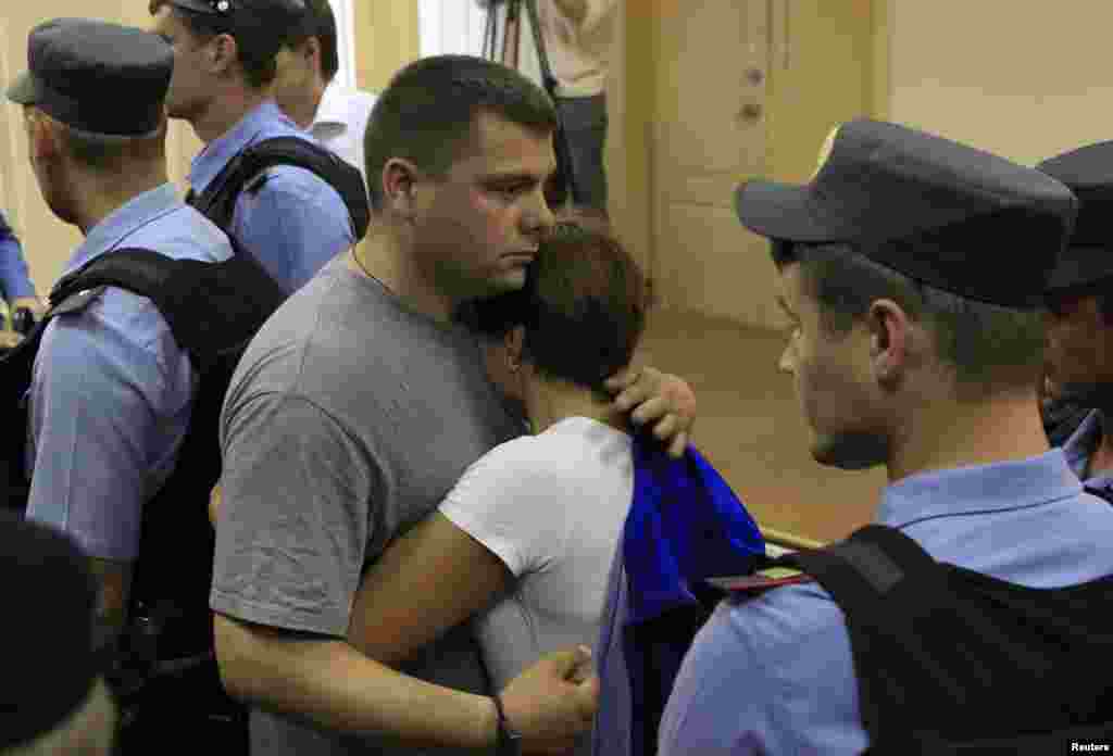 Pyotr Ofitserov (left), Navalny's co-defendant, embraces his wife after the announcement of the verdict in Kirov.