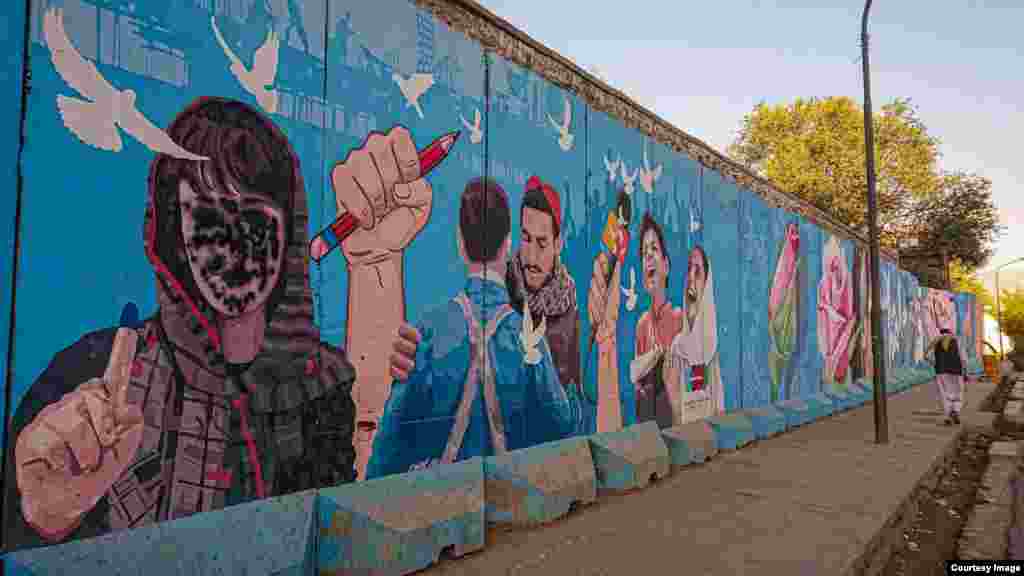 A mural in Kabul featuring a woman voter that has been spray-painted to cover her face 