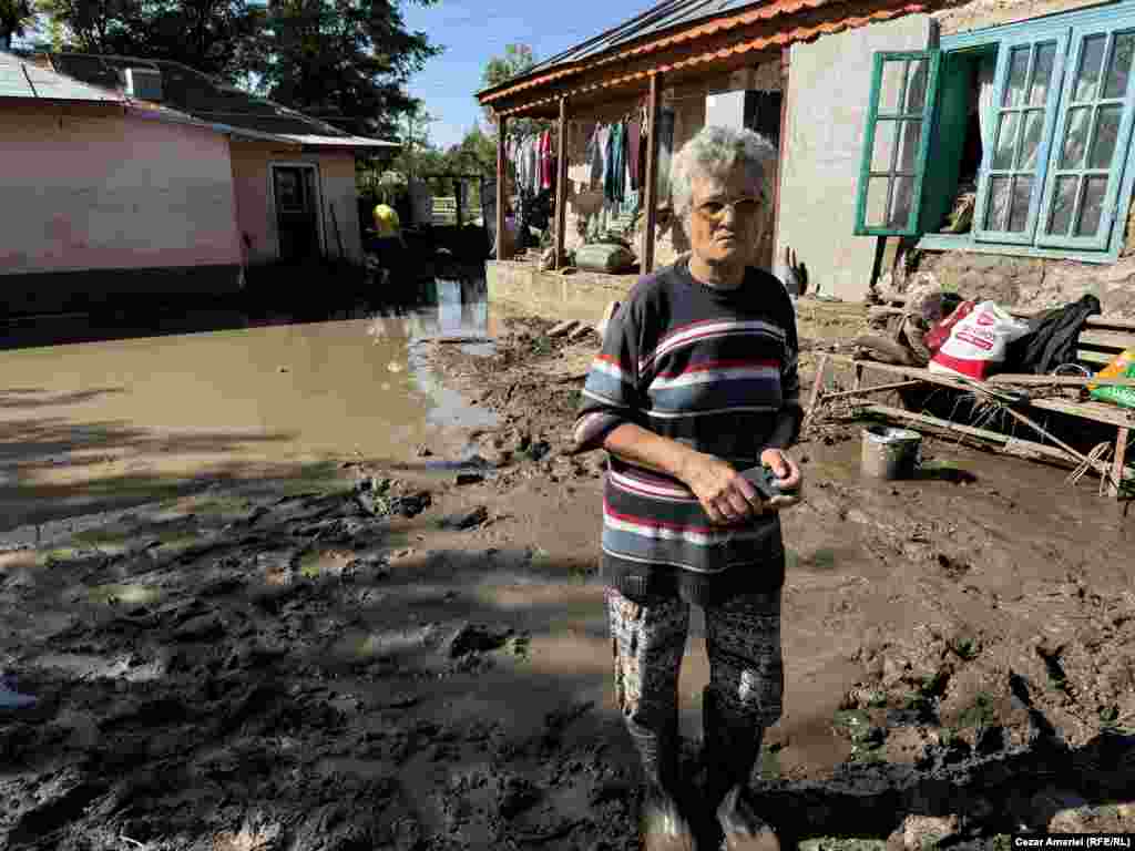 Stefana Bodea, 60, surveys the damage to her home in Slobozia Conachi. She survived the flooding by waiting it out in her attic.