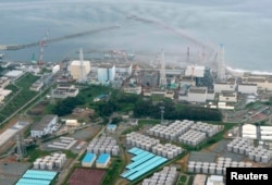 An aerial view of the Fukushima plant and its contaminated-water storage tanks (bottom)