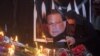 A woman lights a candle next to an image of the governor of Punjab, Salman Taseer, during a candlelight vigil near the site of his assassination in Islamabad.