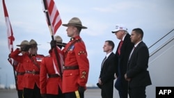 US President Donald Trump steps off of Air Force One upon arrival at Calgary International Airport before the start of the G7 summit.