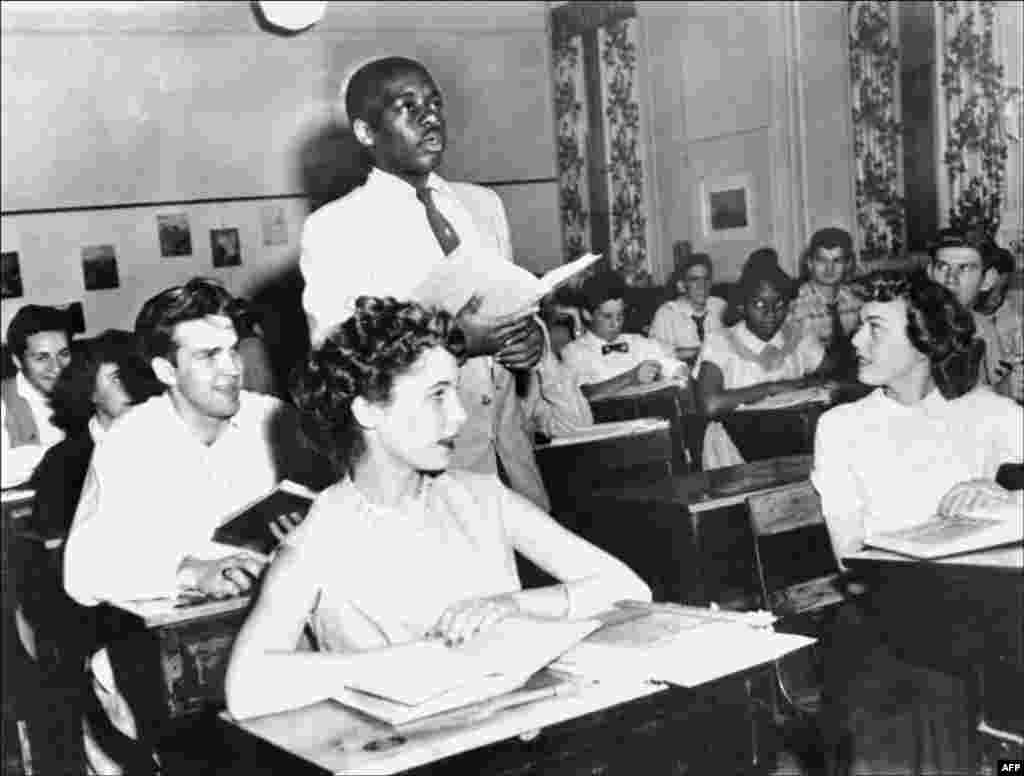 A black student, Nathaniel Steward, 17, recites his lesson on May 21, 1954, at the Saint-Dominique school in Washington, D.C. The school was among the first to hold integrated classes of black and white students following Brown v. Board of Education, the Supreme Court decision outlawing school segregation.