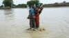 A Pakistani soldier rescues a child from the flood-affected Rajanpur district in Punjab Province on August 2. 