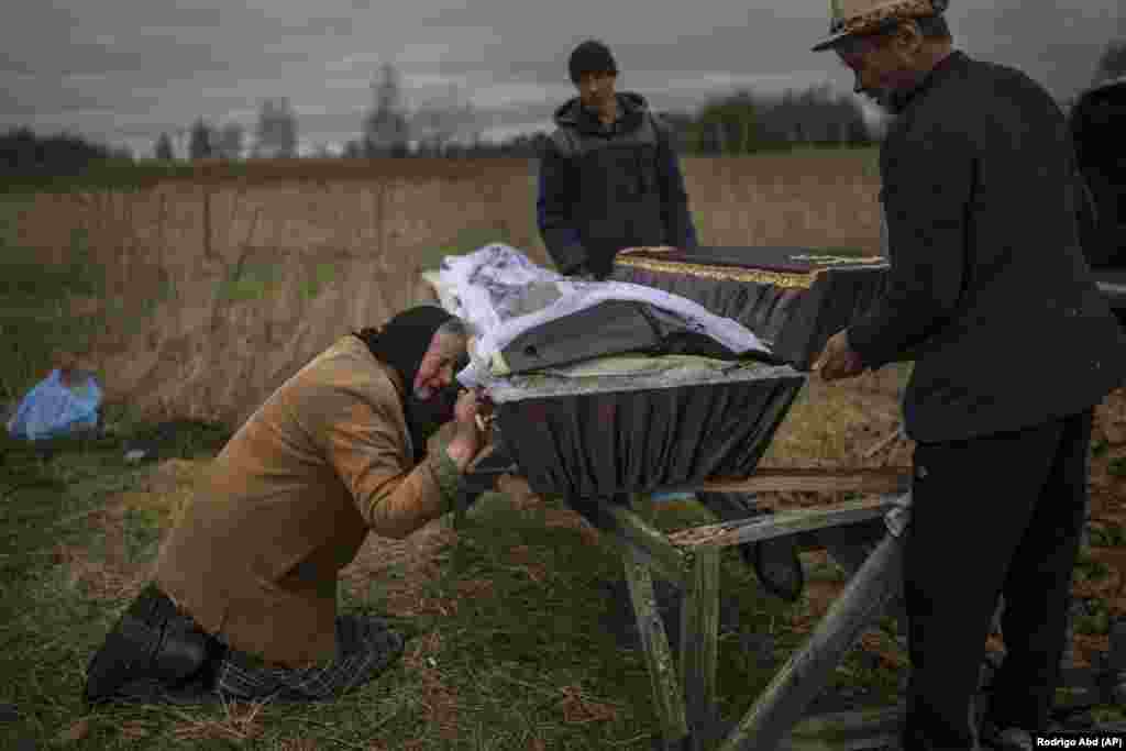 Nadia Trubchaninova, 70, grieves at the coffin of her son, Vadym, in Bucha, near Kyiv, on April 12. Vadym was reportedly killed by Russian soldiers on March 30. 