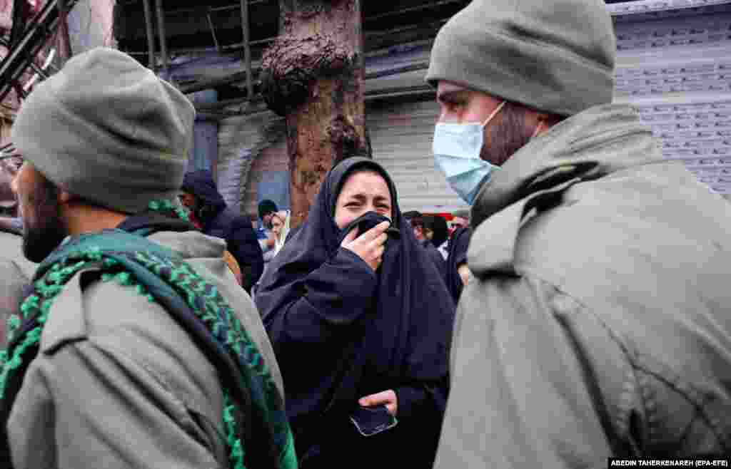 A woman mourns during the funeral of an Iranian security officer in Shahriar. 