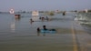 Boys play in floodwaters on the main Indus highway in Sehwan, Pakistan, on September 15.