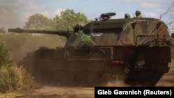 Ukrainian soldier ride a German self-propelled Panzerhaubitze 2000, with the inscription "Good evening, we are from Ukraine!" near the front line. in the Donbas region on July 12.