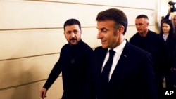 Ukrainian President Volodymyr Zelenskyy and French President Emmanuel Macron leave a joint press conference in Paris on March 26. 