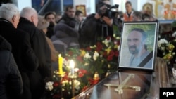 Mourners pass the coffin and photo of Yuriy Verbytskyy, a 51-year-old activist and antigovernment protester on Kyiv's Independence Square, during his funeral in Lviv on January 24.