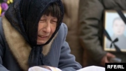 Neanila Palyakova grieves over her daughter's coffin on March 9.
