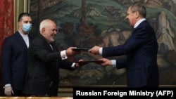 Russian Foreign Minister Sergei Lavrov and his Iranian counterpart, Mohammad Javad Zarif, attend a signing ceremony following their meeting in Moscow on June 16.