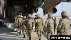 Armenian servicemen board a plane heading for a peacekeeping mission as part of the CSTO in Kazakhstan in January 2022.