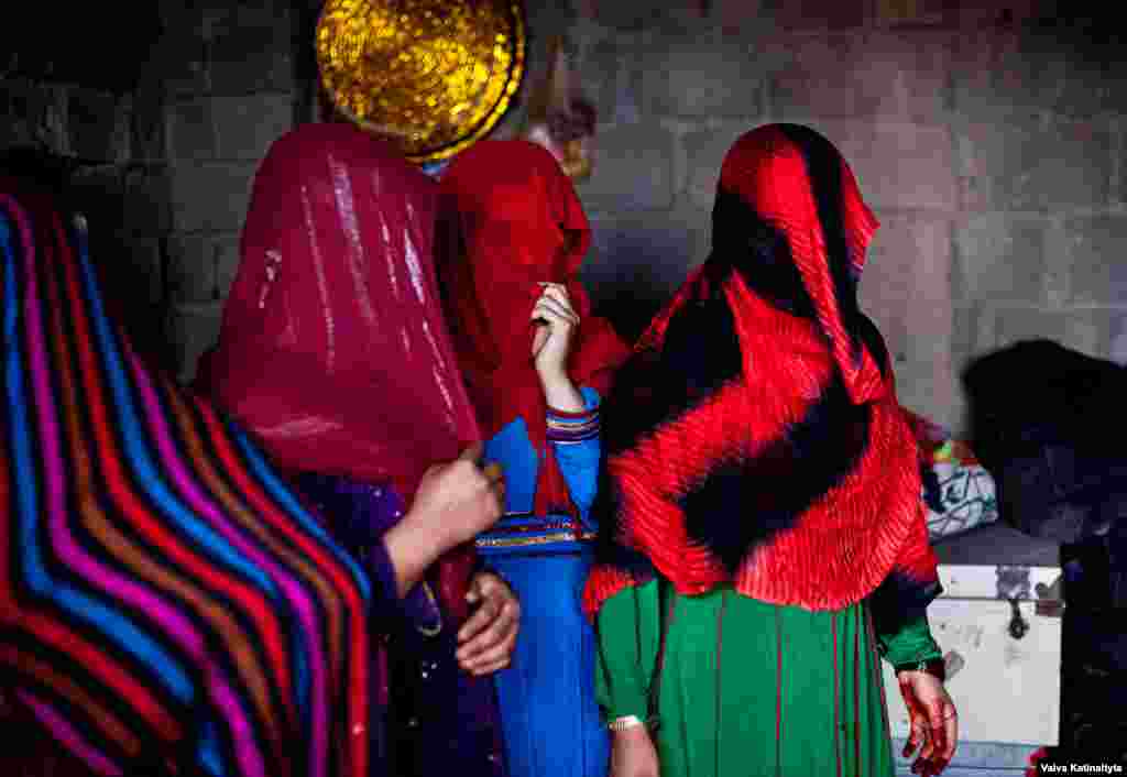 Afghan women cover their faces at their temporary home in Kabul. They are among nearly 90,000 Afghan refugees who have returned from Pakistan in recent months. 