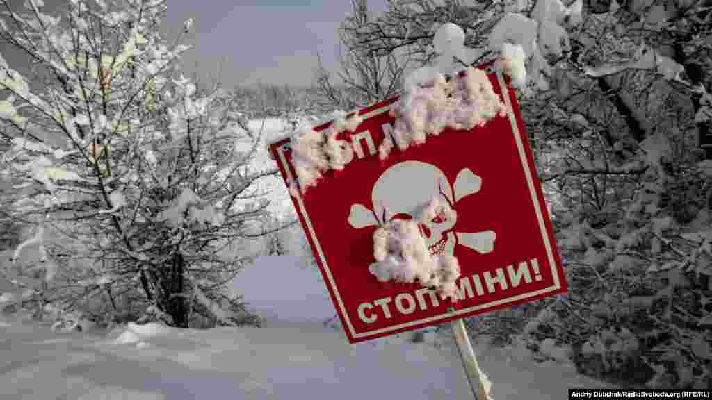On either side of the pedestrian corridor, land mines lurk beneath the fresh snow. 