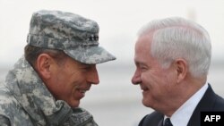 ISAF commander General David Petraeus greets U.S. Defense Secretary Robert Gates (right) in Kabul.