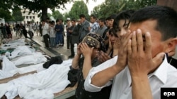 People pray over the bodies of casualties of the government crackdown in Andijon, in eastern Uzbekistan, in May 2005.