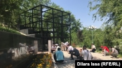 Activists pay their respects to victims of political repression at a monument in Shymkent, Kazakhstan, in May 2020.