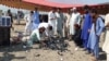 Pashtun Tahafuz Movement activists collect empty tear gas cannisters on October 2, the day after a police raid on their jirga camp.