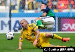 Yaroslav Rakitskyy (in yellow) in action against Northern Ireland at Stade de Lyon in Lyon in 2016.