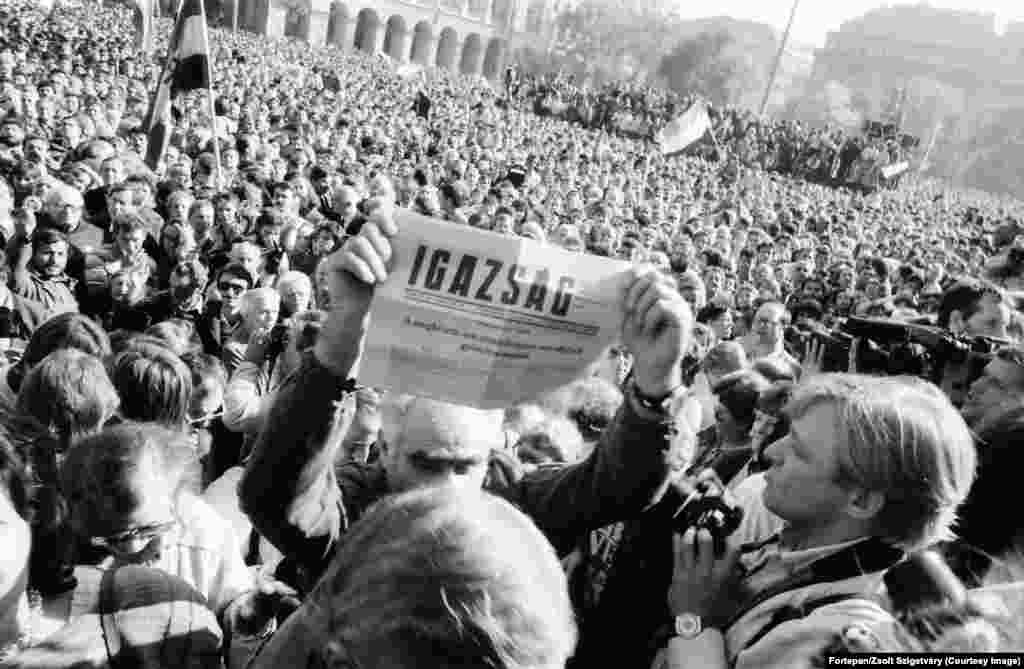 A man holds up a newspaper proclaiming Hungary becoming a democratic republic on October 23, 1989. The headline declares the day an "overdue, but by no means belated victory." Hungary’s parliament soon approved changes to the country’s constitution that opened the door to free elections. The country’s acting president, Matyas Szuros, announced to a crowd of thousands below the parliament building, “'I solemnly declare that as of today, October 23, 1989, Hungary is a republic and its name is the Republic of Hungary." 
