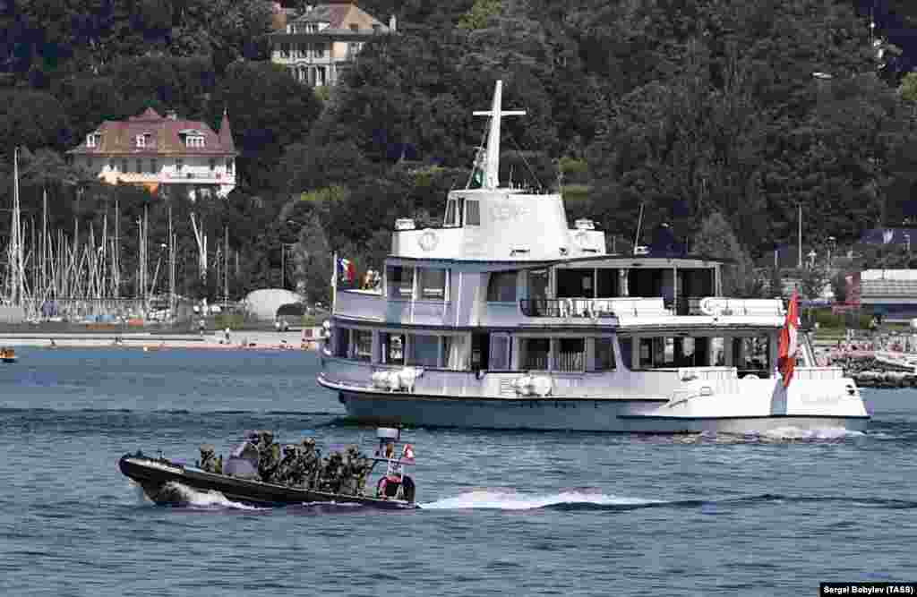 An inflatable boat filled with special forces patrols Lake Geneva on June 15. 