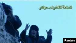 Libyan leader Muammar Qaddafi addresses a crowd gathered in Tripoli's Green Square in this still image taken from video broadcast on Libyan state television on February 25.