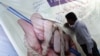 A Pakistani journalist signs a banner during a protest against the deteriorating security situation for journalists in the country and to mark World Press Freedom Day in Karachi in May 3.