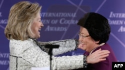 U.S. Secretary of State Hillary Clinton (left) greets Kyrgyzstan President Roza Otunbaeva at the "International Women of Courage" awards ceremony at the State Department in Washington on March 8.