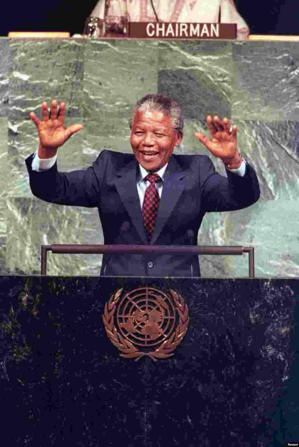 Nelson Mandela acknowledges the cheers of United Nations delegates during a speech to the UN Committee Against Apartheid in the General Assembly Hall in June 1990.