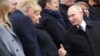 Russian President Vladimir Putin (right) greets German Chancellor Angela Merkel and U.S. President Donald Trump as they attend a commemoration ceremony for Armistice Day in Paris on November 11.