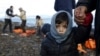 Greece -- A Syrian refugee child looks on, moments after arriving on a raft with other Syrian refugees on a beach on the Greek island of Lesbos, January 4, 2016