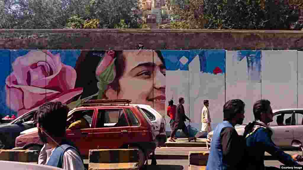 The young woman’s face disappearing under white paint as the workers advance 