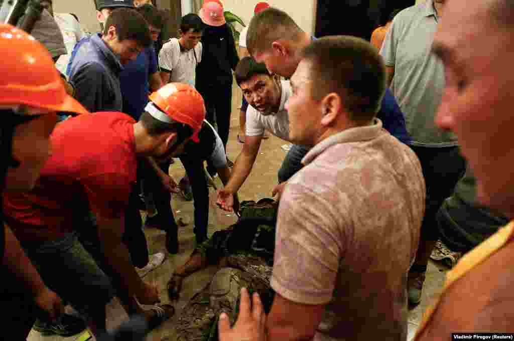 Supporters of Atambaev surround an apparently unconscious member of the special forces team. One policeman was shot dead in the operation. 