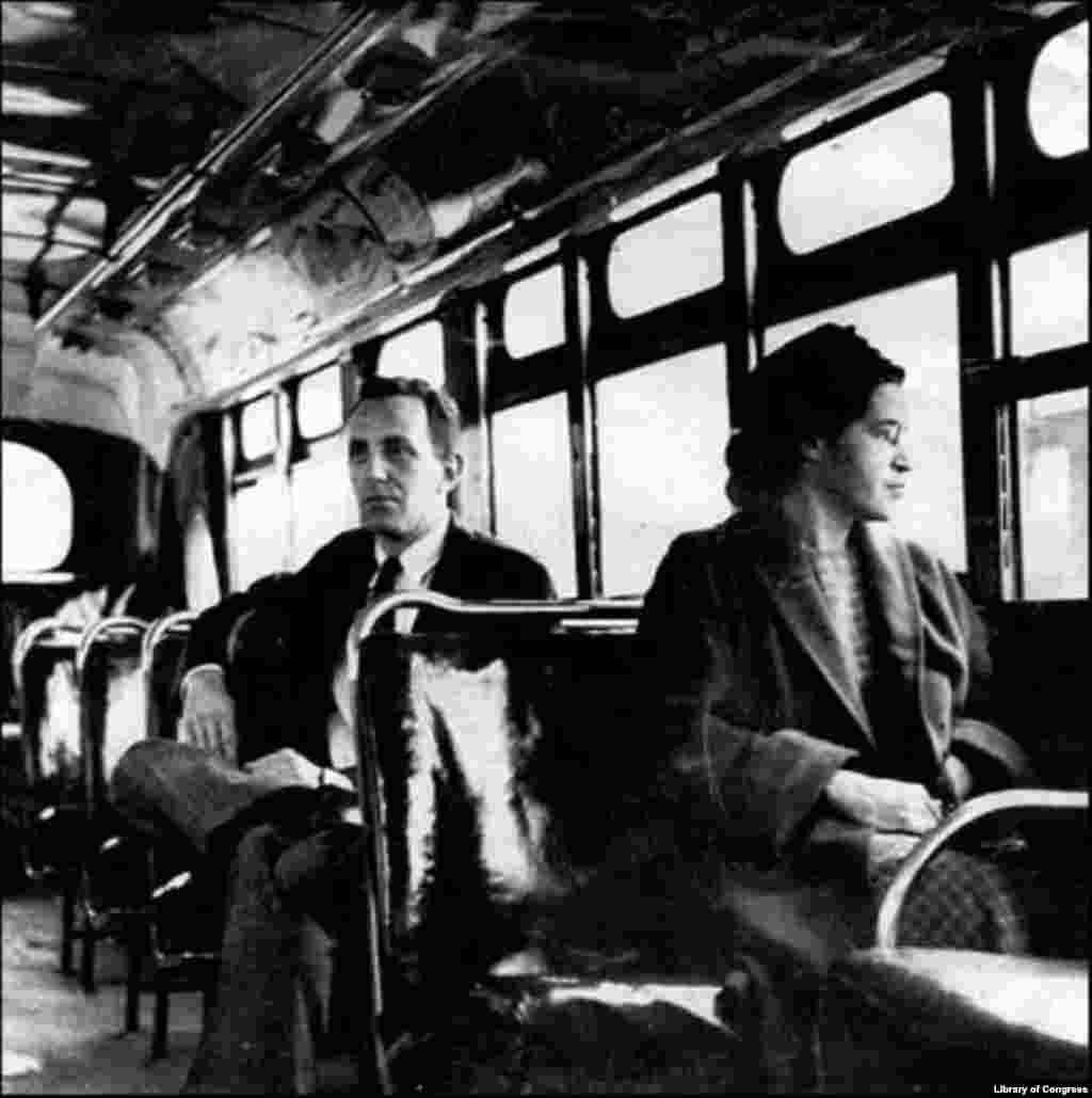 Rosa Parks sits with a journalist in the front of a bus in Montgomery, Alabama, in 1956, after the U.S. Supreme Court ruled segregation illegal on the city's transport system. The court case was the result of the bus boycott initiated by Parks and fellow activists.