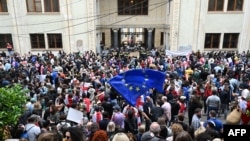 Demonstrators protesting the "foreign agent" law crowd outside the parliament building in central Tbilisi on May 28.