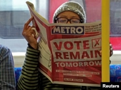 A woman reads a newspaper on the London Underground that urges voters to remain in the European Union.