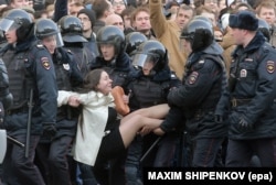 Russian riot policemen detain a demonstrator during an opposition rally in central Moscow in March.