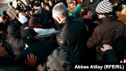 Four protesters were reportedly taken away by police with blood on their faces.