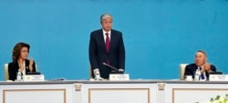 Qasym-Zhomart Toqaev (center) stands as Nursultan Nazarbaev (right) and his daughter, Darigha, applaud during the Nur Otan party congress on April 23.