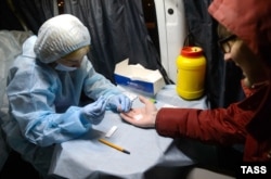 A man takes a blood test at a mobile HIV testing unit in Yekaterinburg earlier this month.