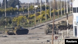 Syrian tanks are seen in Bab Amro near the city of Homs on February 12.