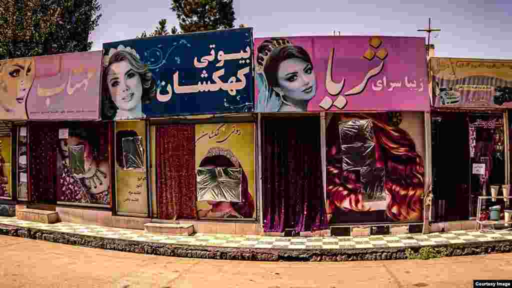 A row of beauty salons in which women’s faces -- at least those within easy reach -- have been hastily covered by foil