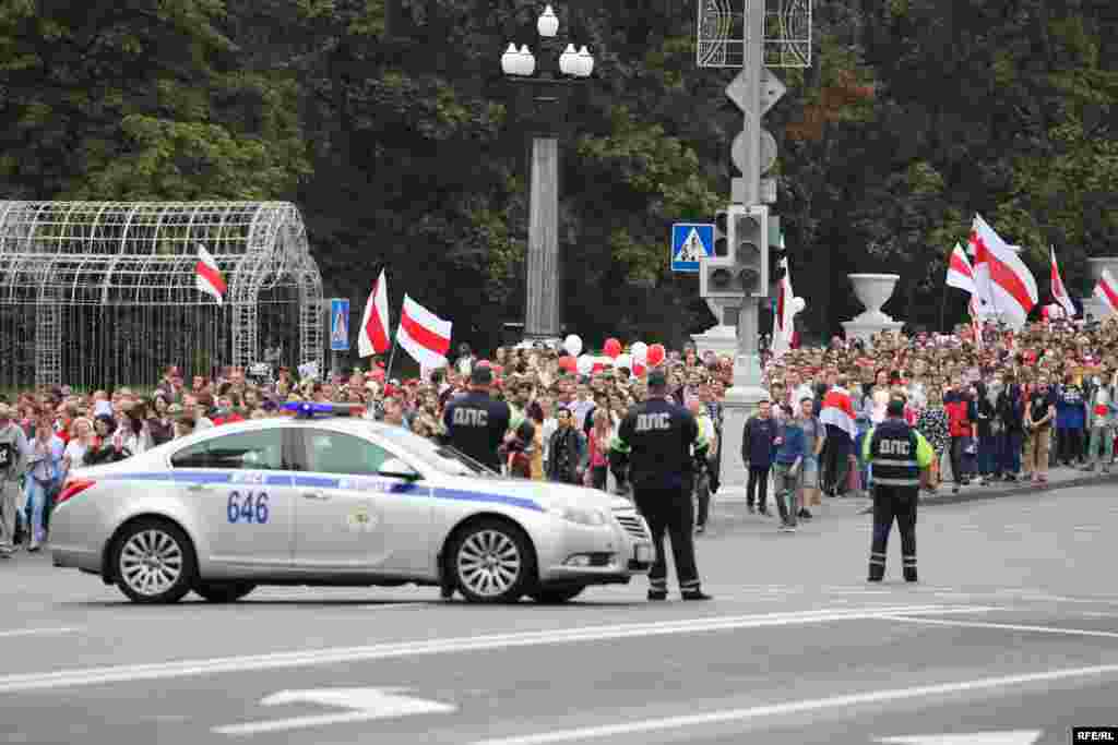 Police watch as protesters make their way toward the central rallying point on Independence Square. 