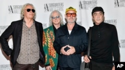 R.E.M. band members Peter Buck (left), Mike Mills (second left), Michael Stipe (second right), and Bill Berry attend the Songwriters Hall of Fame Induction and Awards Gala in New York last year. 