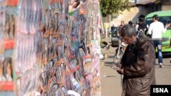 An Iranian man looks at election posters during a week of campaigning ahead of a parliamentary poll on March 2